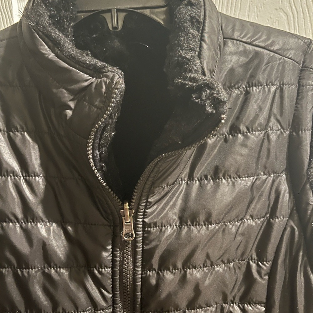Size LARGE vest. Black with fur like material lining. Puffy outside. Very warm